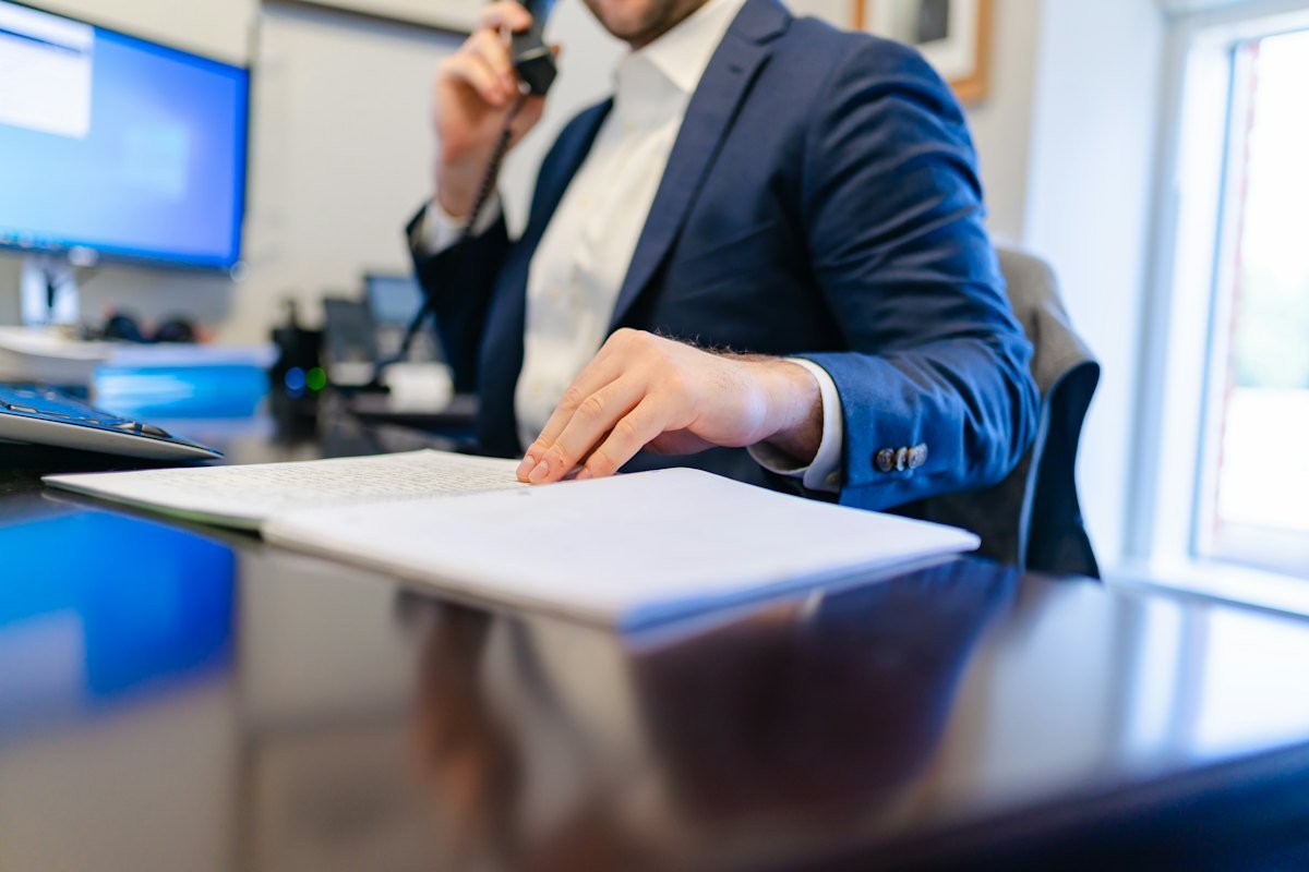 A career strategist reading through a printed resume draft at a desk